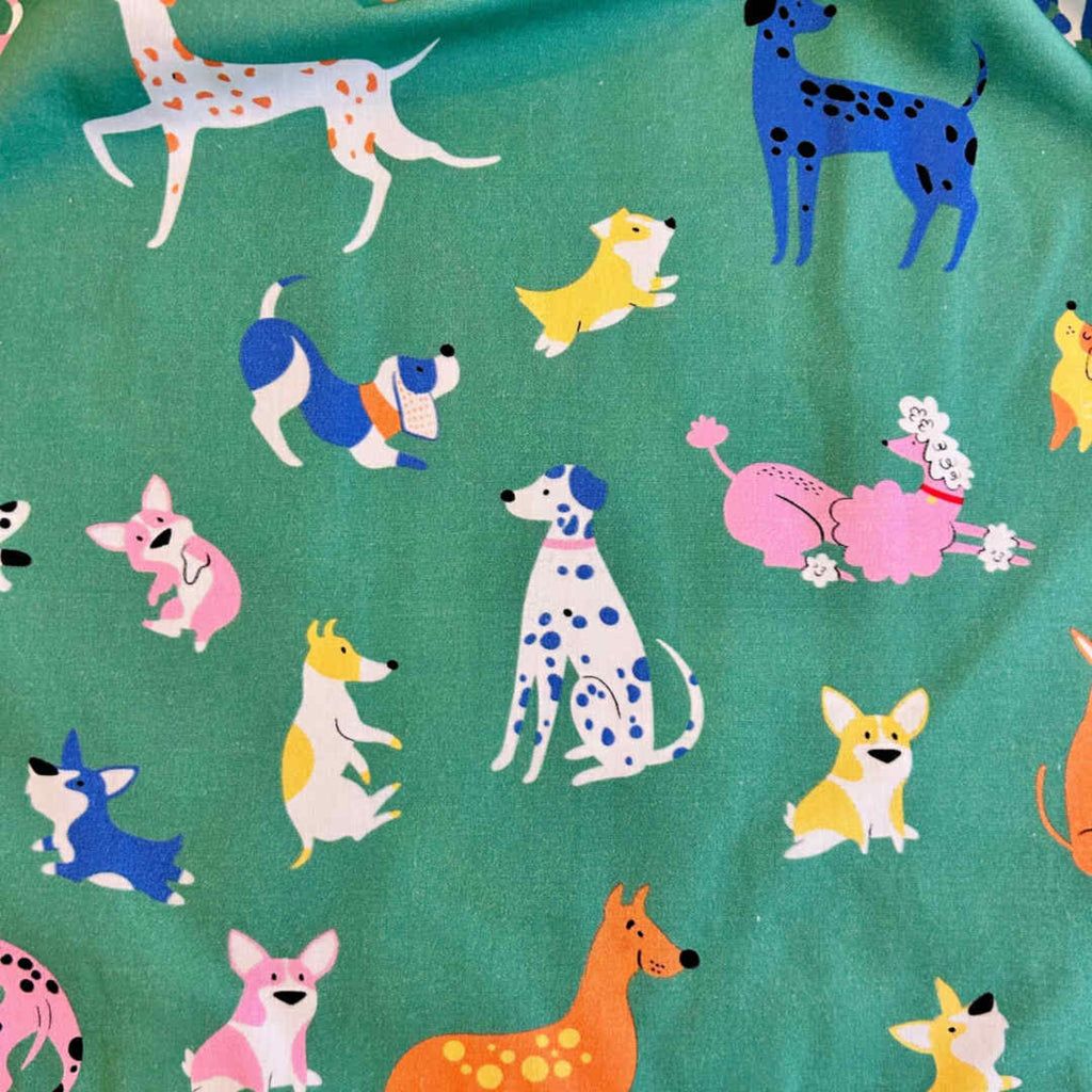 Pattern of colorful dogs on a green background