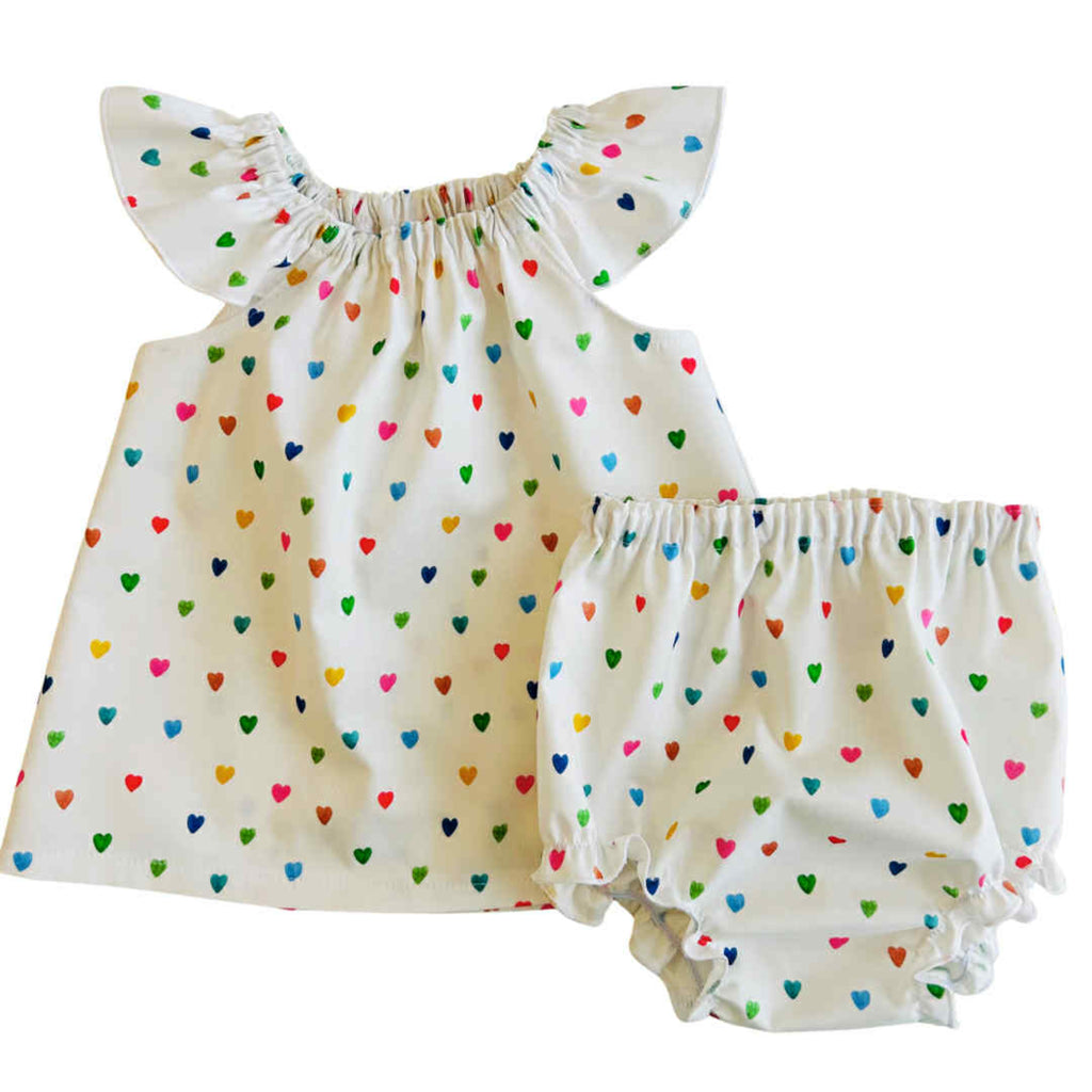 Baby outfit with colorful heart pattern on a white background