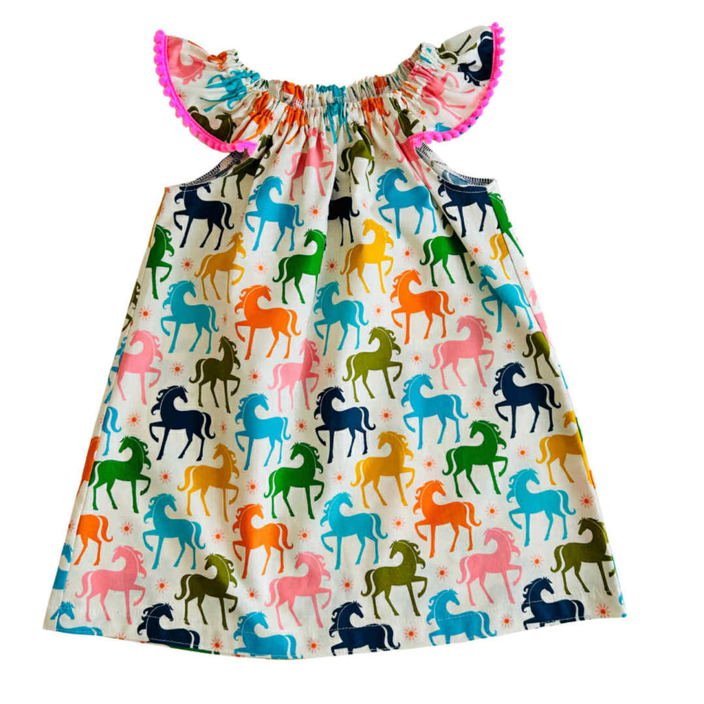 Dress with colorful horse pattern on a white background