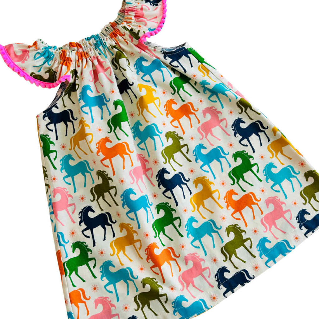 Dress with colorful horse pattern on a white background