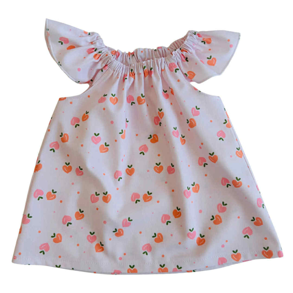 White dress with peach pattern on a white background