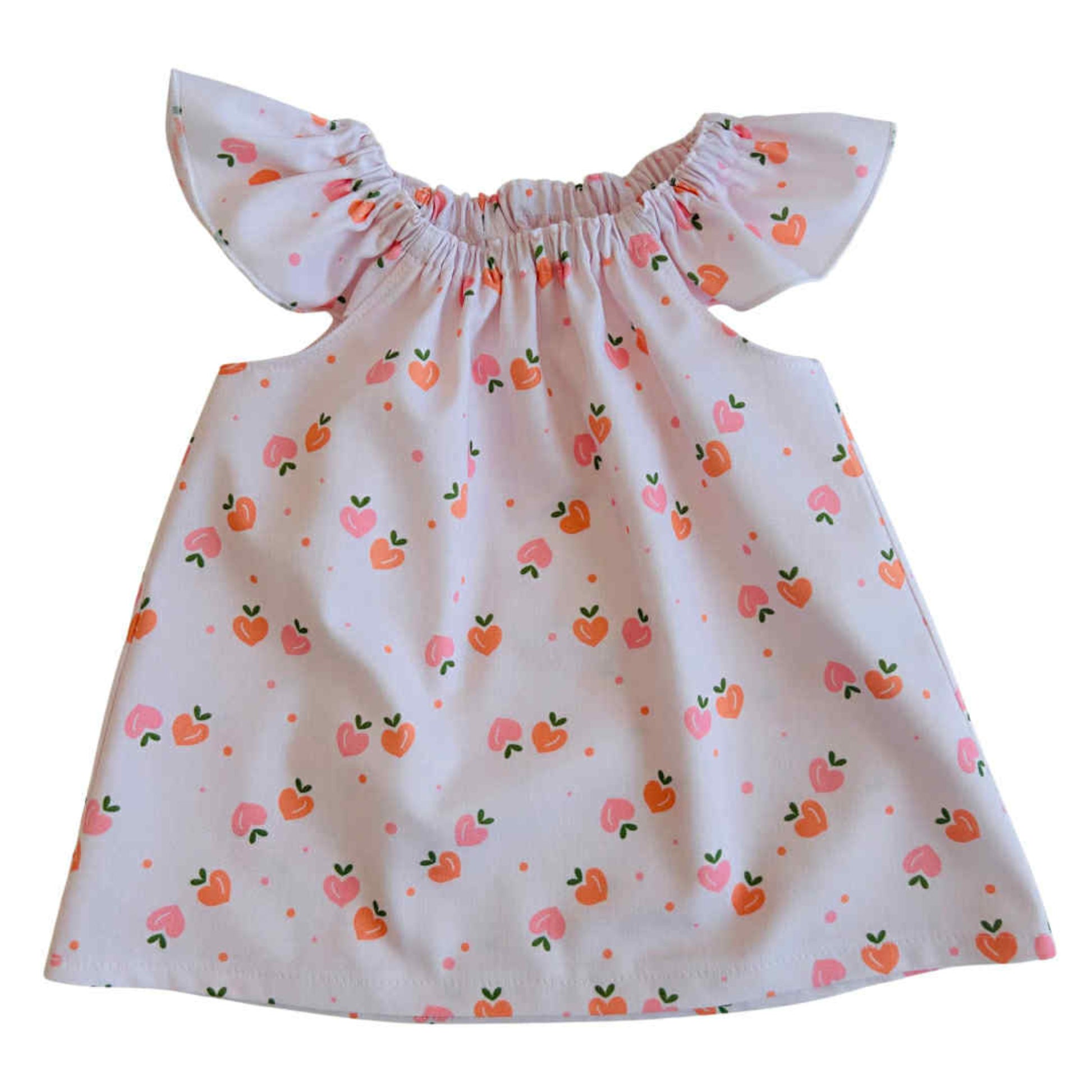 White dress with peach pattern on a white background